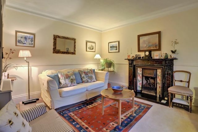 The original cast iron fireplace lends an element of cosy warmth to the sitting room.
