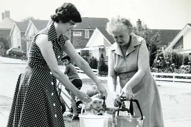 Collecting water from newly-installed stand pipes on Primley Park Road in Alwoodley in August 1976.