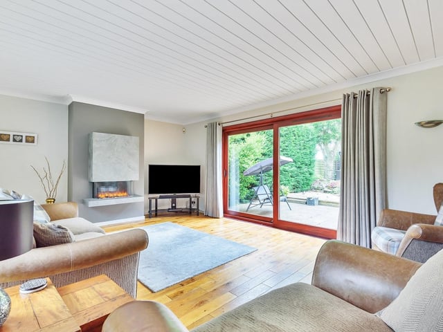 A stunning fireplace and access outdoors to the patio from this bright lounge.