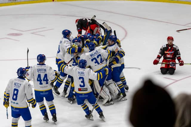 PARTY TIME: Leeds Knights' players mob Jordan Buesa (hidden) after his overtime winner against Swinon Wildcats on Sunday evening. Picture: Knights Media.