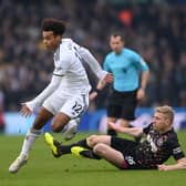 LEEDS, ENGLAND - JANUARY 22: Leeds player Tyler Adams skips the challenge of Ben Mee during the Premier League match between Leeds United and Brentford FC at Elland Road on January 22, 2023 in Leeds, England. (Photo by Stu Forster/Getty Images)