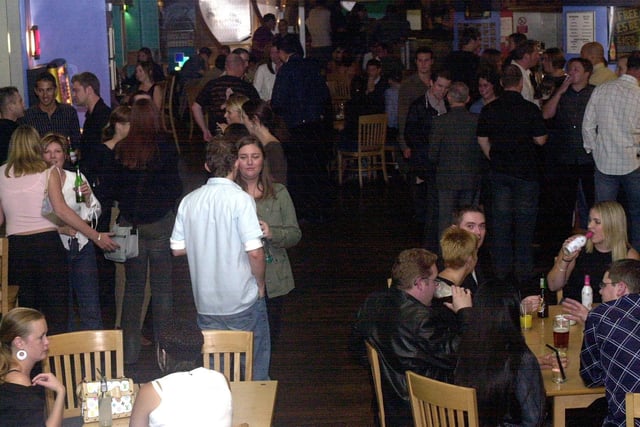 Drinkers on a typical Friday night at the Qube Bar in September 2003.