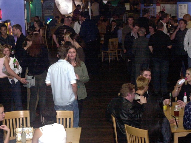 Drinkers on a typical Friday night at the Qube Bar in September 2003.