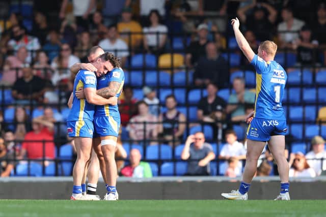 Lachie Miller celebrates as a relieved Brodie Croft is congratulated following his winning drop goal for Leeds Rhinos at London Broncos. Picture by John Clifton/SWpix.com.