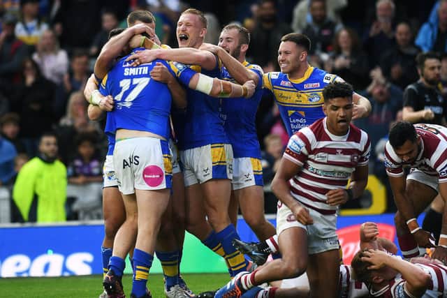Rhinos celebrate Cameron Smith's try against Wigan. Picture by Jonathan Gawthorpe.