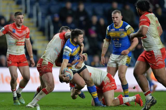 Tom Briscoe offloads during Rhinos' home loss to St Helens this season. Picture by Bruce Rollinson.