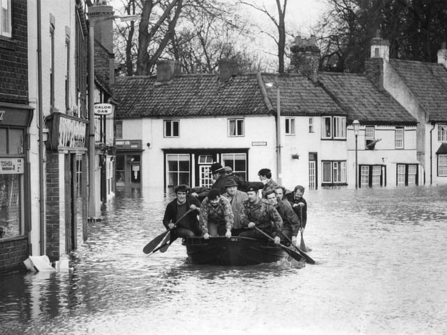 Soldiers and policemen turned to paddle power to ferry stranded people from their homes on Fishergate in January 1982.