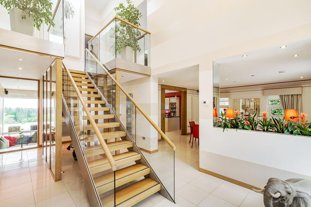 A stunning wood and glass staircase leads to the first floor where four double bedrooms can be located.