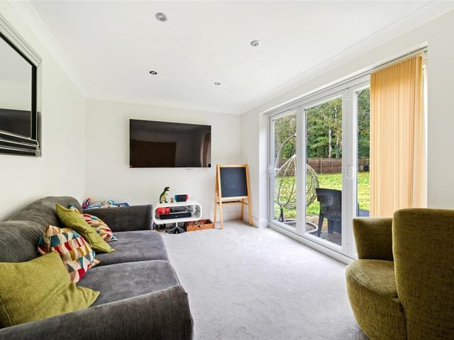Adjacent to the kitchen is a spacious versatile snug area, providing a cozy and inviting space to relax and unwind.