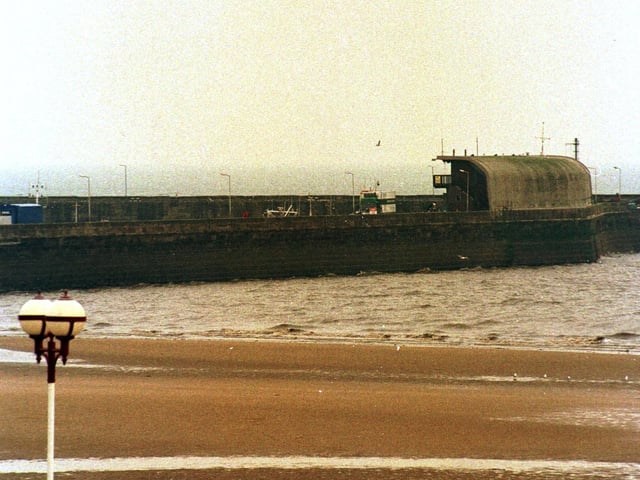 A walk along a clean beach. Bridlington South side beach won a award for cleanliness in March 1999.