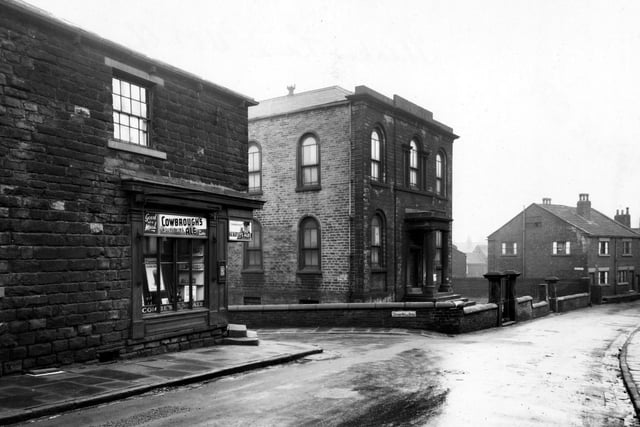 This photo shows the Methodist Chapel and Carruthers Beer Retailers on Theaker Lane. The junction with Eyres Mill Side is on the left. Advertisements for Tetleys, Guiness and Cowbroughs nourishing ales are visible in the shop window. Pictured in January 1948.