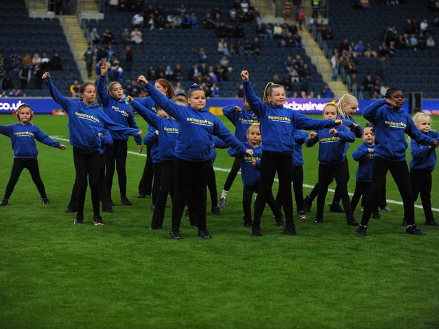Rhinestones dancers perform on the pitch at AMT Headingley.