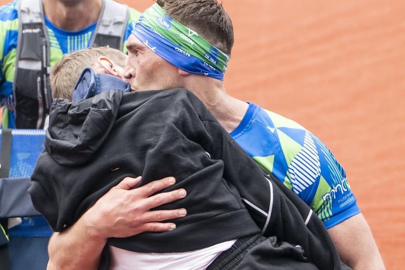 Kevin Sinfield kisses Rob Burrow as he carries him across the finish line of the 2023 Rob Burrow Leeds Marathon