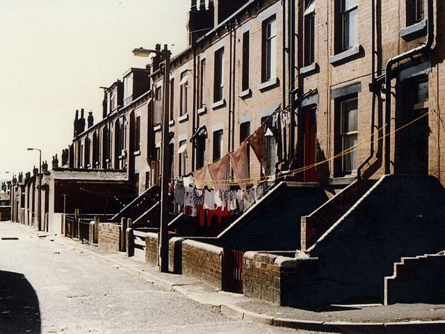 Beeston's Back Lodge Lane showing the rear of terraced houses on Lodge Lane. All have small back yards, some with washing lines, some with out-buildings. This is the south-west side of Back Lodge Lane running from Stratford Terrace to Trentham Street.