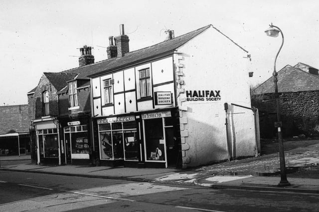 Shops on Commercial Street in Rothwell. On the far right can be seen the entrance to Gas Works Yard, and shops are, from left, William Denton & Sons, estate agents at number 50, also with an office of Halifax Building Society, then Susan Jayne Boutique at 52, and the premises of M.Green, sweet shop, an number 54. Beyond that can be seen the turning into Meynell Avenue, and a new building housing more shops at numbers 60-62.