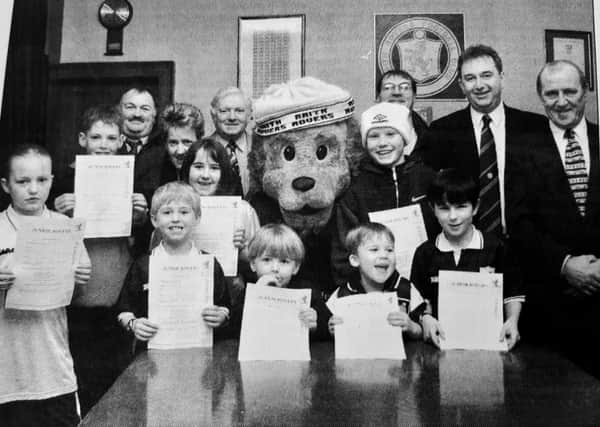 February 1999 saw Raith Rovers launch their Junior Rovers  Club to encourage more youngsters along to support the tam
Launching it with mascot Roary Rover are some young helpers with club volunteers Ian Stewart, Linda Patrick, Jim MacNamara, Kenny Grainer, Ally Gourlay, and Cliff Brady