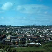 An aerial view of Meanwood from Woodhouse Ridge, looking across a rugby ground and fields towards Grove Lane running along the bottom in June 1973. The Meanwood Hotel public house is on the bottom right at the junction with Meanwood Road. Bentley Lane runs up on the far left with Bentley Primary School on its right hand side, while Stainbeck Road runs up on the right. Much of the housing in between the two, mainly terraces, has since been demolished and replaced by semi-detached housing.