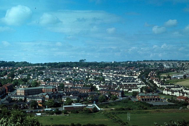 An aerial view of Meanwood from Woodhouse Ridge, looking across a rugby ground and fields towards Grove Lane running along the bottom in June 1973. The Meanwood Hotel public house is on the bottom right at the junction with Meanwood Road. Bentley Lane runs up on the far left with Bentley Primary School on its right hand side, while Stainbeck Road runs up on the right. Much of the housing in between the two, mainly terraces, has since been demolished and replaced by semi-detached housing.