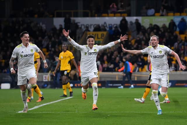 WOLVERHAMPTON, ENGLAND - MARCH 18: Luke Ayling of Leeds United celebrates after scoring their side's third goal with Robin Koch and Rodrigo Moreno during the Premier League match between Wolverhampton Wanderers and Leeds United at Molineux on March 18, 2022 in Wolverhampton, England. (Photo by Laurence Griffiths/Getty Images)