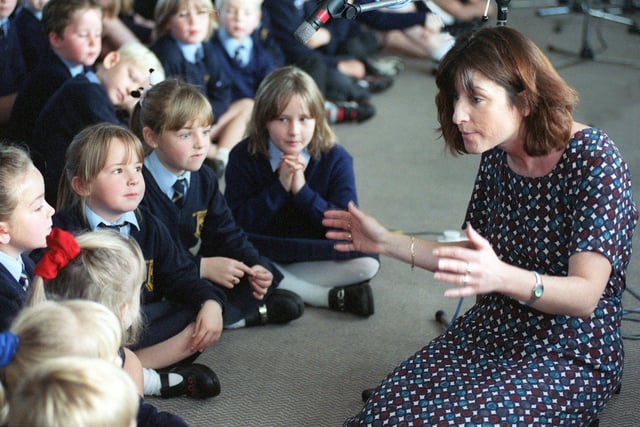 This is Jenny Stuart, a music teacher at St Gregory's RC Primary pictured in October 1999. She is helping pupils practise the lyrics of 'The New Millennium'  a song they were recording at the West Park Centre.