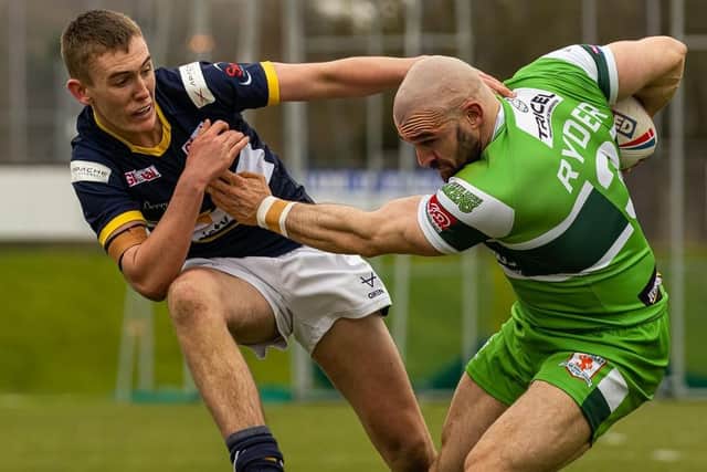Hunslet's Adam Ryder, pictured tangling with Fin Balback of Leeds Rhinos during the pre-season Harry Jepson Trophy derby. Picture by Paul Whitehurst/Hunslet RLFC.