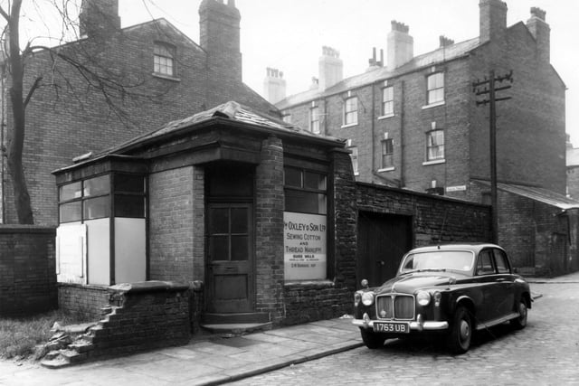 January 1961 and on the left of this view is a small one-storey shop building on Grove Terrace in Little London. This was the business of William Oxley and Son Ltd, cotton manufacturers. This company was based in Ashton-Under-Lyme near Manchester. A car is parked on Back Grove Terrace. Newton Terrace is visible in the background.