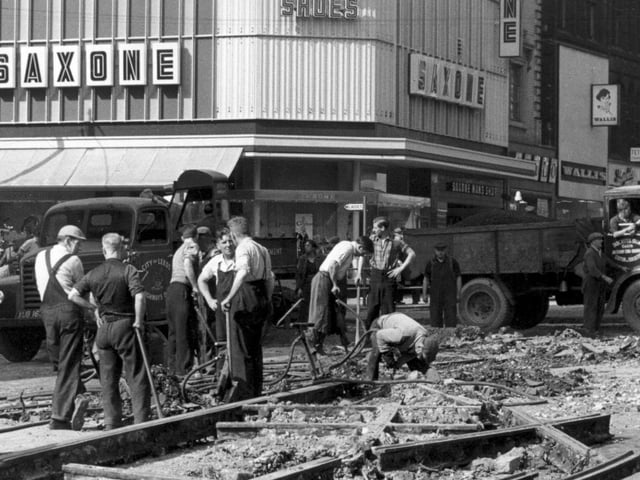 Workmen removing tramlines at the junction of Boar Lane, left, and Briggate, right. Taken sometime in the late 1950s or early 1960s.