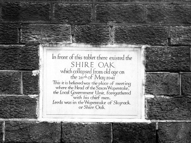 Shire oak memorial tablet on Otley Road. Close up of an inscribed tablet marking the site of a local Saxon Wapentake meeting place under a shire oak tree which collapsed in May 1941.
