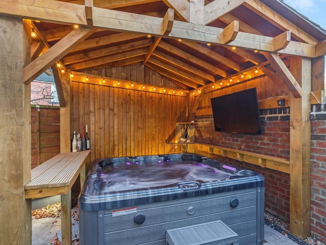 The rear garden is laid to low maintenance astroturf and also features a pergola-covered hot tub, available by separate negotiation.