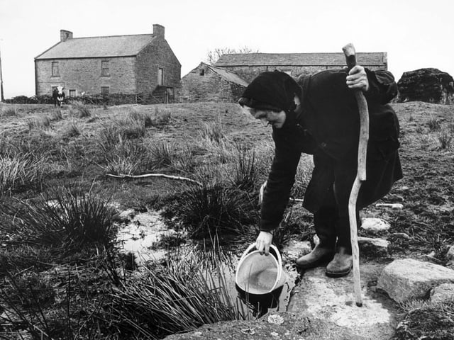 Farmer Hannah Hauxwell is pictured drawing her water for domestic use at her farm in Baldersdale.