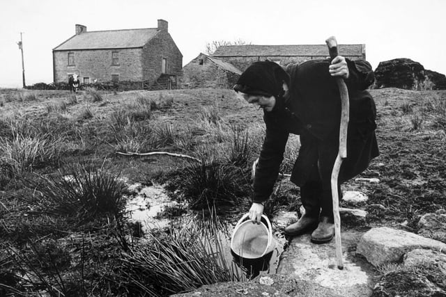 Farmer Hannah Hauxwell is pictured drawing her water for domestic use at her farm in Baldersdale.