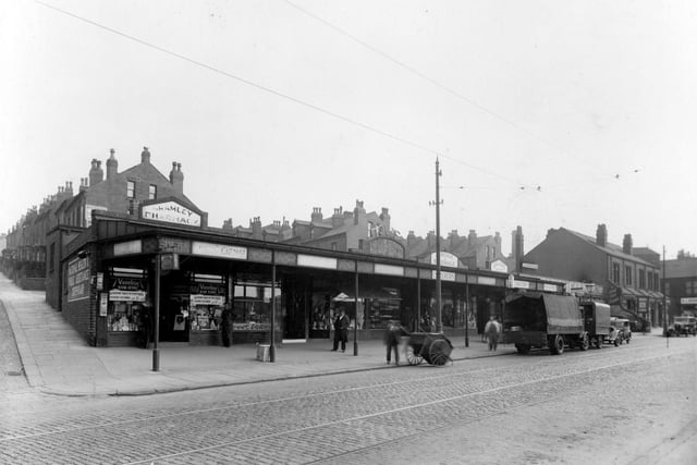 Shops on Station Parade on Stanningley Road in May 1938. On the left is the junction with Station Mount. Chemist Norman Whitaker is on the corner. Armitage and Baxendale caterers, drivers, grocers can also be seen.