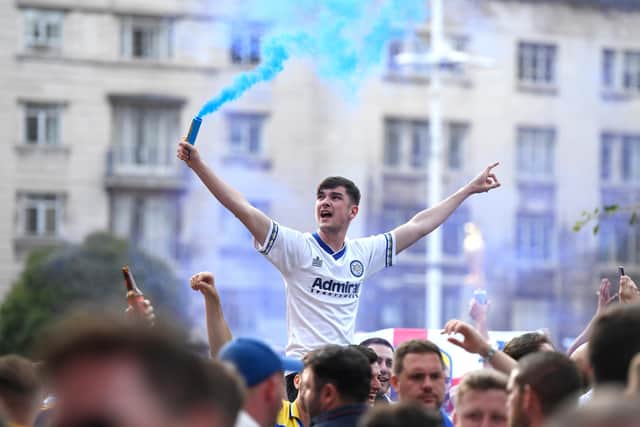 LEEDS, ENGLAND - JULY 19: Leeds United fans celebrate after winning the Sky Bet Championship title at Millennium Square on July 19, 2020 in Leeds, England. (Photo by George Wood/Getty Images)
