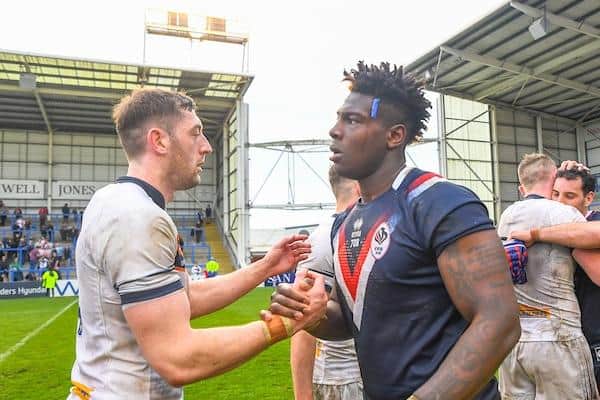 Rhinos' Justin Sangare, who was among the France substitutes, shakes hands with England’s Jake Wardle after the game. Picture by Olly Hassell/SWpix.com.
