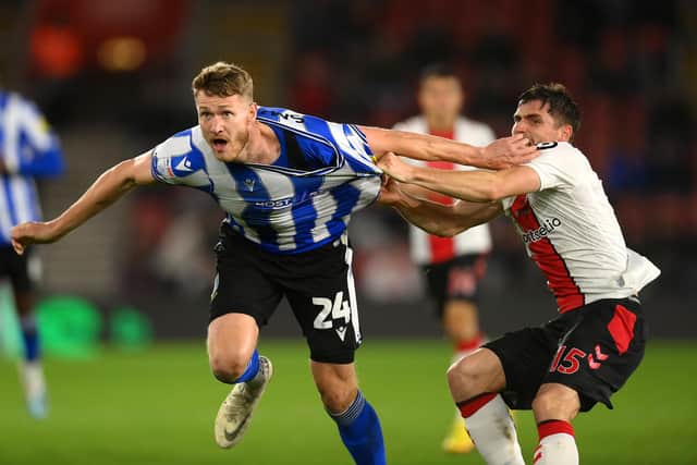 SOUTHAMPTON, ENGLAND - NOVEMBER 09: Michael Smith of Sheffield Wednesday is challenged by Romain Perraud of Southampton during the Carabao Cup Third Round match between Southampton and Sheffield Wednesday at St Mary's Stadium on November 09, 2022 in Southampton, England. (Photo by Mike Hewitt/Getty Images)