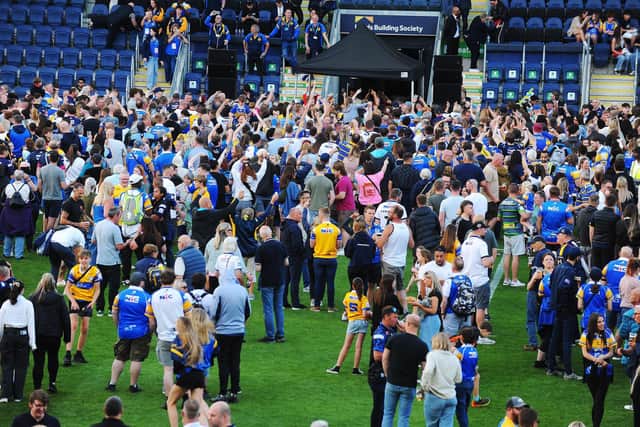 Leeds Rhinos fans party on the pitch at AMT Headingley following the win against Warrington Wolves. Picture by Steve Riding.