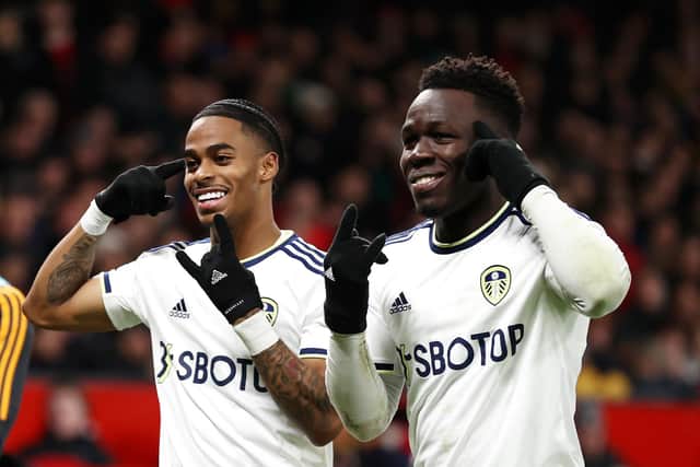 MANCHESTER, ENGLAND - FEBRUARY 08: Crysencio Summerville and Wilfried Gnonto of Leeds United celebrate after Raphael Varane of Manchester United concedes an own goal, the second goal for Leeds United, during the Premier League match between Manchester United and Leeds United at Old Trafford on February 08, 2023 in Manchester, England. (Photo by Naomi Baker/Getty Images)