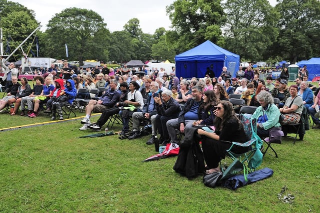 The umbrellas are put away, for now, as the audience soak up the performances. (pic by Steve Riding)