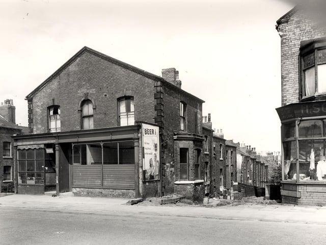 Camp Road in July 1958. Glover Street is on the left, numbers 74, 74a are two shops which appear to be empty. On the right is a view down Back Glover Street. The shop partly in view on the right is number 72, selling clothes and material. Faded lettering above the shop has the name H. Soloman.
