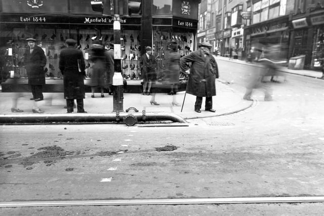 The junction with Briggate and Commercial Street. Manfield and Sons Boot and Shoemakers on corner. Pictured in April 1942.