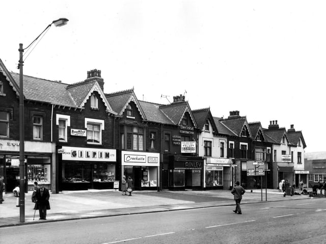A parade of shops on Roundhay Road numbered (from left) 275 to 291. These include John Gilpin Ltd., bakers and confectioners, at no.277 with Margaret McDonald, coiffeur, above. Next right is Crockatt's cleaning followed by Ainley (Leeds) Ltd., electrical engineers and Doreen, ladies' fashions. At the end of the parade, by the junction with Harehills Lane (known as Harehills Corner) is the Leeds and Holbeck Building Society at no.291. Across the road at no.293 is the Yorkshire Penny Bank. Pictured in June 1966.