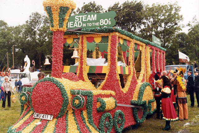 This spectacular float was Lewis's entry to the 7th Annual Lord Mayor's Parade, seen here on Woodhouse Moor before departure. The staff of Lewis's department store had constructed the steam engine of the American West, using bales of straw covered in over 20,000 red, green and gold ribbon bows of type used on parcels. Lewis's staff can be seen in costume derived from the American West, including native North Americans and 'saloon girls'. Lewis's won the 'Lord Mayor's Award for Best Overall Entry'.