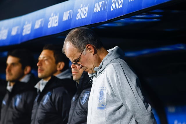 Bielsa bows his head in the dugout as the national anthems are played before kick-off (Photo by Ernesto Ryan/Getty Images)