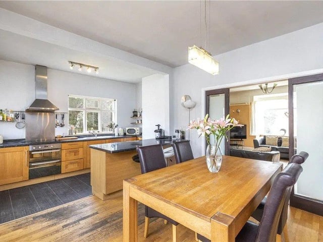 The family dining kitchen has beautiful wooden cabinets and plenty of countertop space for cooking.