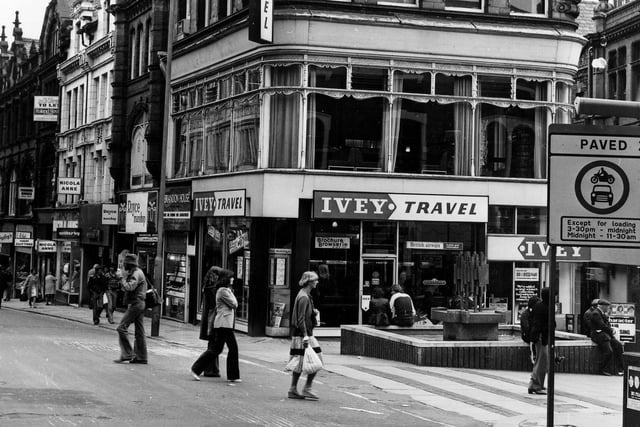 Lands Lane precinct at the corner with Albion Place. The fountain and precinct were opened on the April 12, 1972 by Environment Secretary Peter Walker. From the left, on Albion Place, shops include Bailey's, Nicola Anne, Willerby, Royce Manshop Ltd at number 27, Brandon House Ltd jeweller's at 28 and Ivey Travel at number 6 Lands Lane. A sign in the foreground informs that Lands Lane is a paved zone with vehicle restrictions.