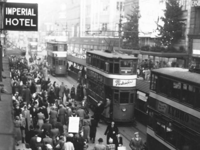 Trams wait for Christmas shoppers in December 1953.
