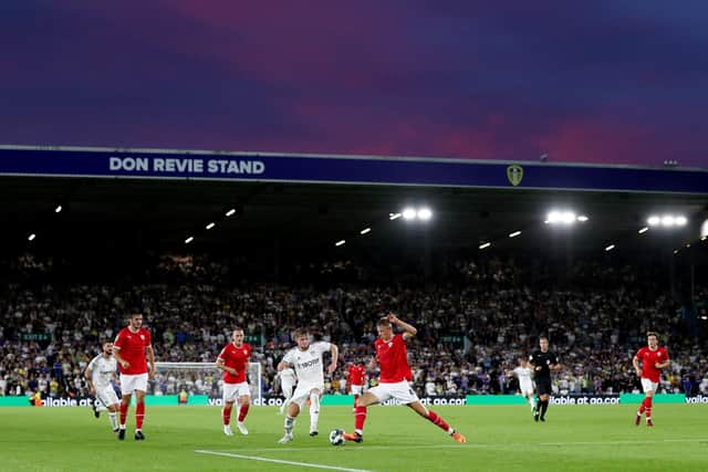 LEEDS, ENGLAND - AUGUST 24: Joe Gelhardt of Leeds United battles for possession with Mads Andersen of Barnsley as the sun sets around the stadium during the Carabao Cup Second Round match between Leeds United and Barnsley at Elland Road on August 24, 2022 in Leeds, England. (Photo by George Wood/Getty Images)