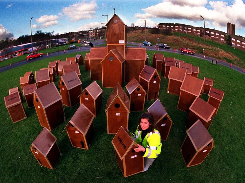 Artist Gill Russell with her Cardboard City on the Leeds Ring Road roundabout near Pudsey. Pictured in February 1998.