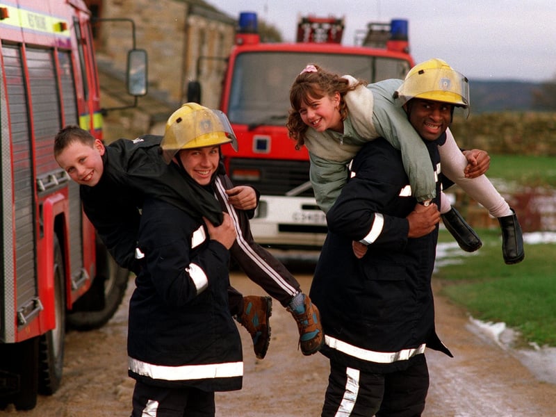 Fire fighters from Moortown Fire Station visited Lineham Farm at Eccup to present a cheque for £300 as part of the proceeds raised at the station's annual open day. Pictured are firefighters Ian Storey (left) and Junior Linton giving youngsters Kyle Alexander and Charlotte Reed a fireman's lift.