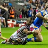 Liam Tindall is tackled by Wigan's Thomas Leuluai during Rhinos' semi-final win last week. Picture by Allan McKenzie/SWpix.com.